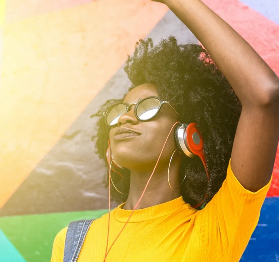 A woman with headphones on and her eyes closed.