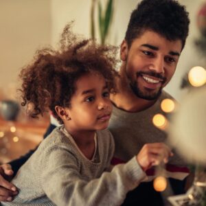 A man and child are playing video games.