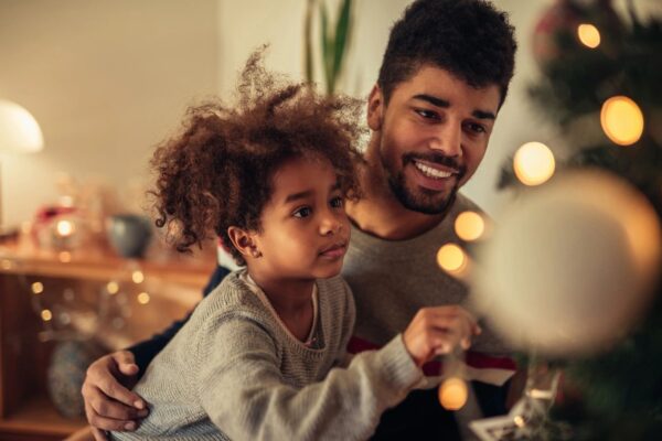 A man and child are playing video games.