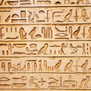 A close up of the egyptian hieroglyphs on a wall