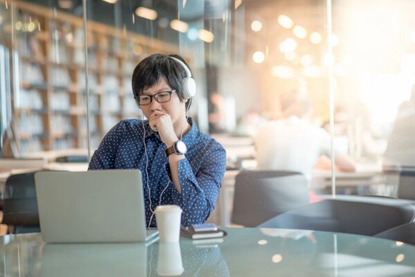 A man sitting at a table with headphones on.