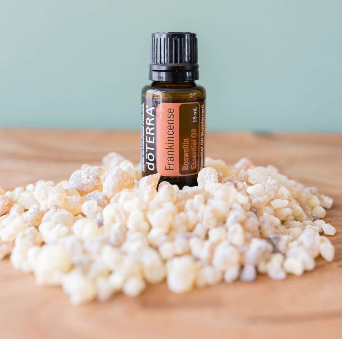 A bottle of essential oil sitting on top of popcorn.