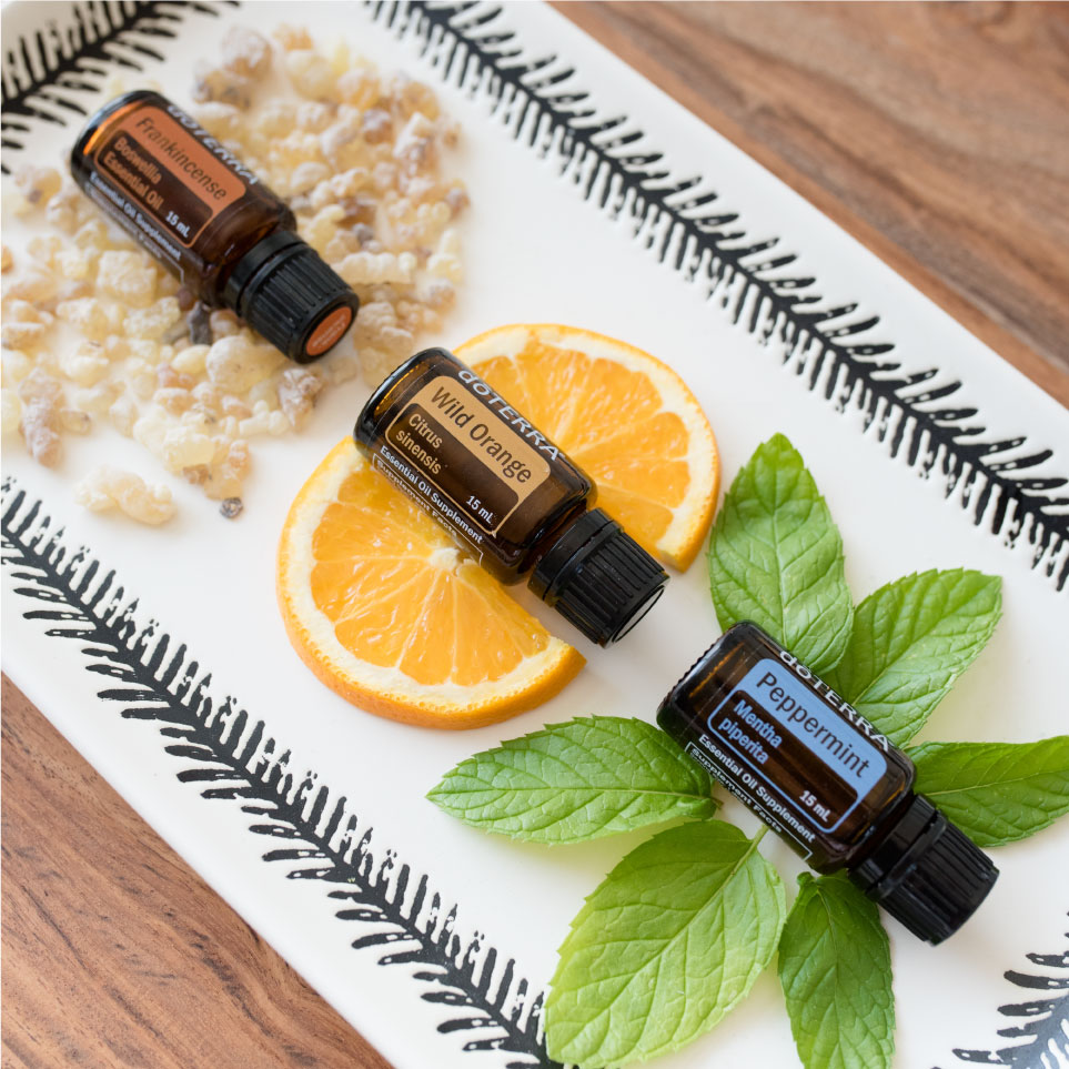 Three bottles of essential oils sitting on a tray.