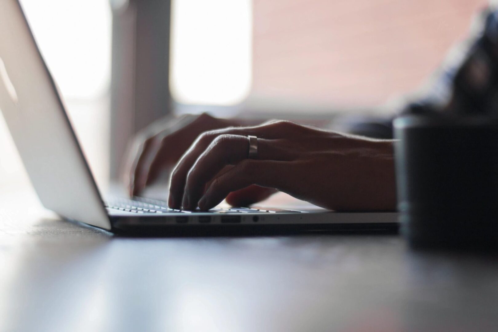 A person typing on a laptop computer.