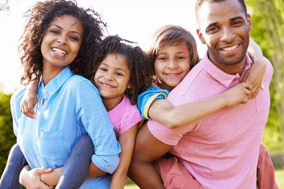 A family of four posing for the camera.