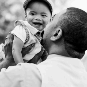 A man holding a baby in his arms.