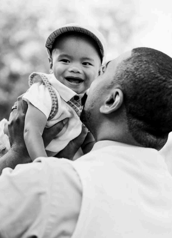 A man holding a baby in his arms.